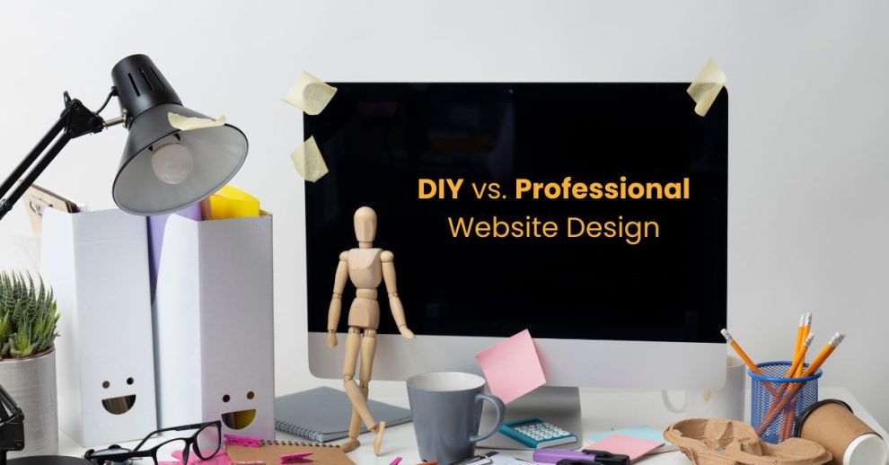 A creative desktop setup featuring a monitor displaying the text “DIY vs. Professional Website Design,” surrounded by stationery, a lamp, and a wooden mannequin symbolizing the contrast between self-made and expert-built websites.