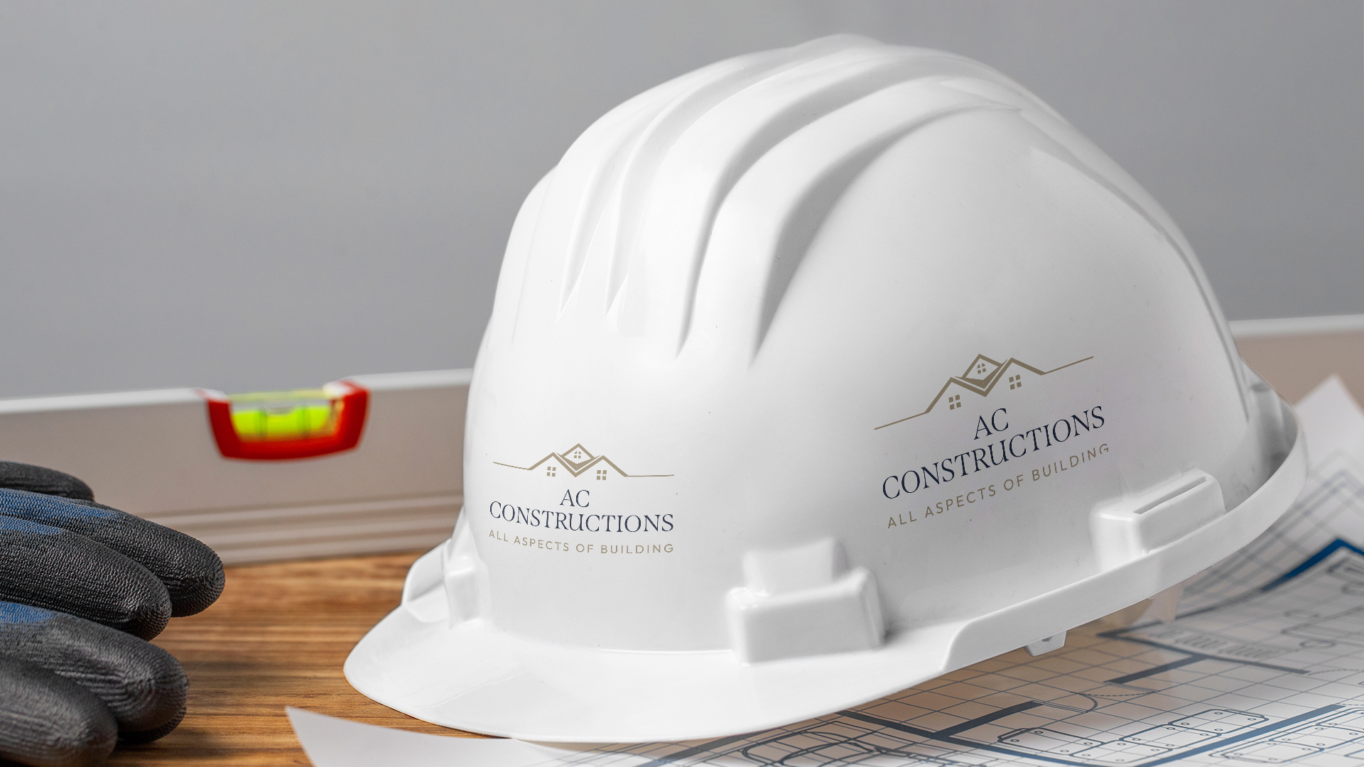A logo mockup on An industrial safety helmet for a builder company that work on building houses